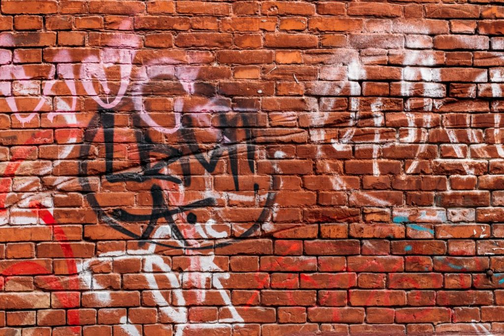 brick wall with paint and graffiti