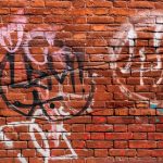 brick wall with paint and graffiti