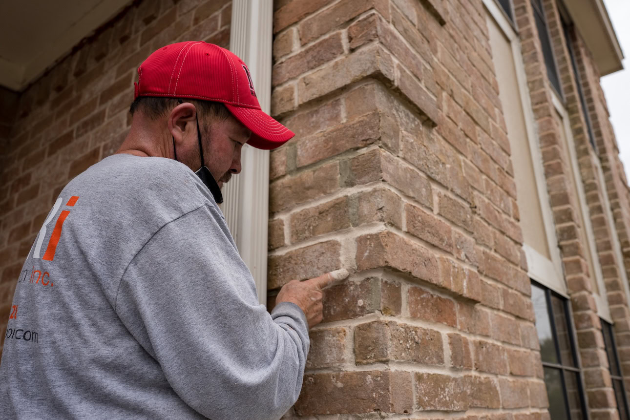 brick restoration mason repairing mortar