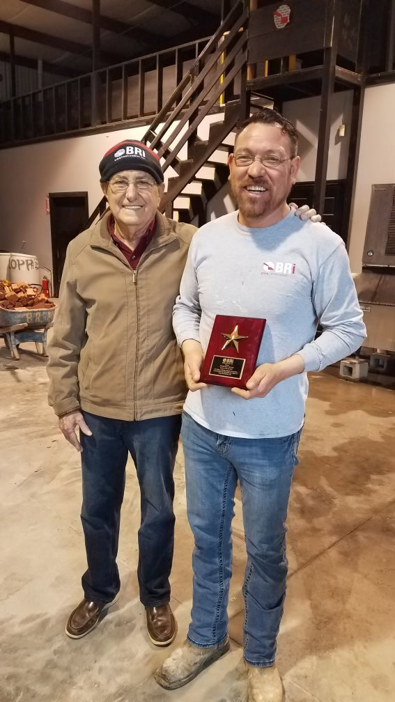 Roberto Presenting Employee With Award