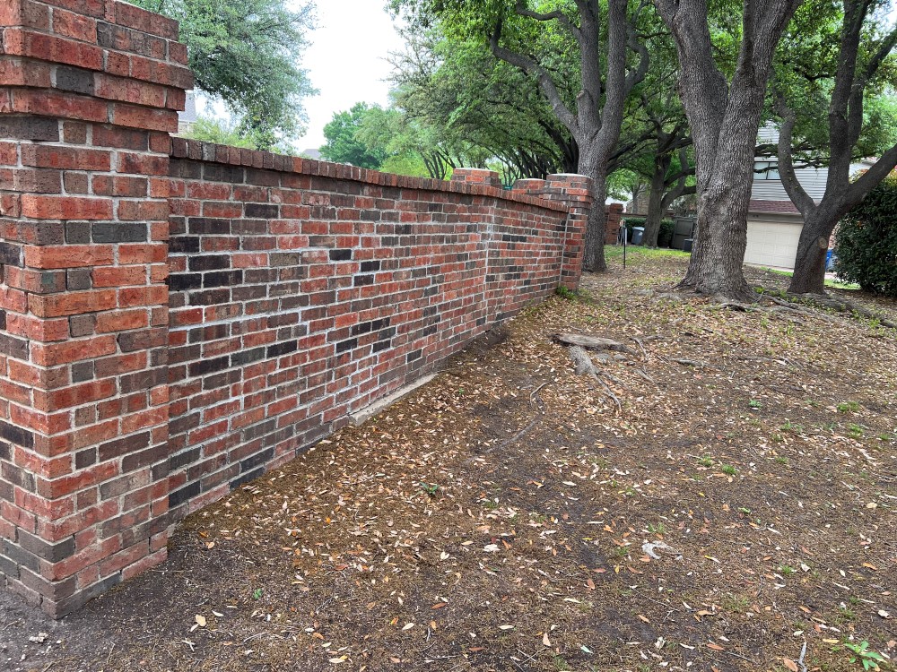 Leaning Brick Perimeter Fence