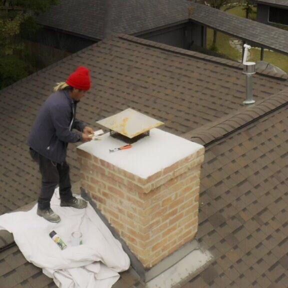 Brick Restoration Masonry Specialist Repairing Chimney on Roof