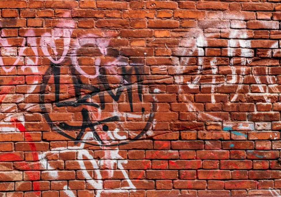 brick wall with paint and graffiti