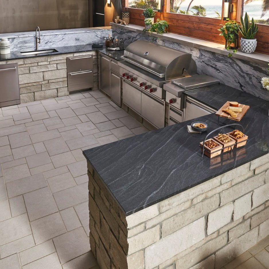 Outdoor Kitchen With Stone Veneer and Pavers